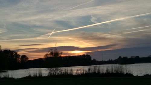 Scenic view of silhouette trees against sky during sunset