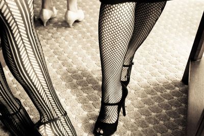 Low section of woman standing on tiled floor