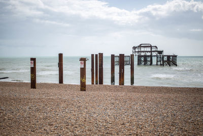 Lifeguard hut on beach against sky