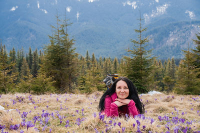 Portrait of young woman standing in forest