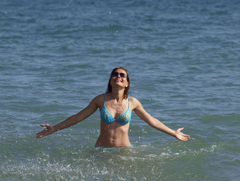 Portrait of young woman in water