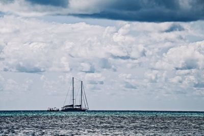 Sailboat sailing on sea against sky