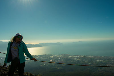 Man standing on mountain against sky