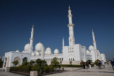 Low angle view of sheikh zayed mosque against clear blue sky