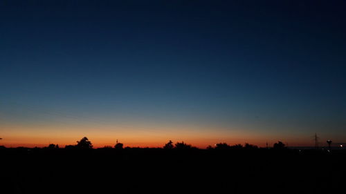 Scenic view of silhouette landscape against clear sky at sunset