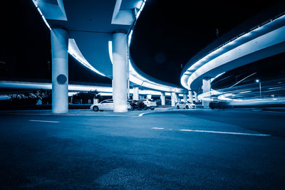 Illuminated bridge in city at night