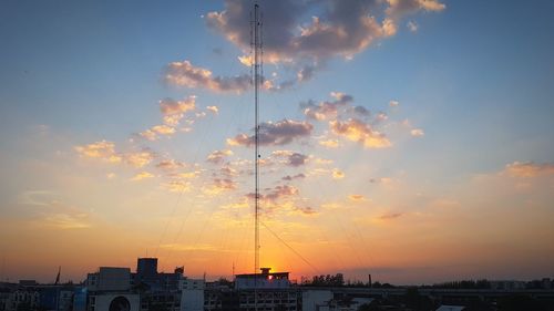 Silhouette buildings against sky during sunset