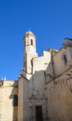 Low angle view of historic building against clear blue sky