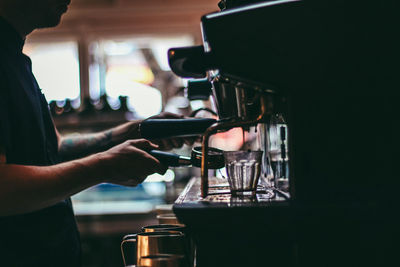 Close-up of hands preparing coffee