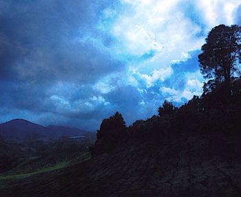 Scenic view of mountains against cloudy sky