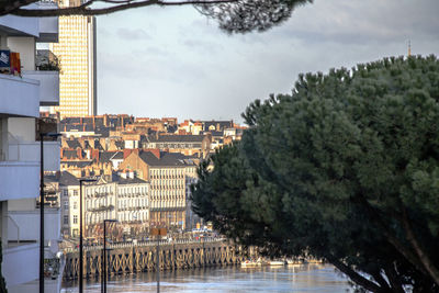 High angle view of river by buildings against sky