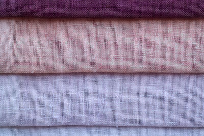 Detailed close up view on samples of cloth and fabrics in different colors found at a fabrics market