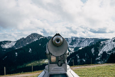 Binoculars against mountains during day