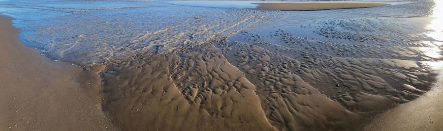 High angle view of wet sand on beach