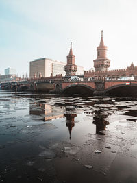 Bridge over river with buildings in background