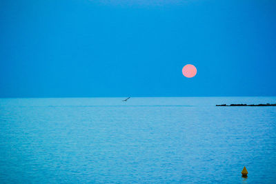 Scenic view of sea against blue sky