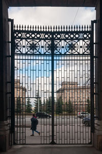 Man walking on building seen through window