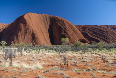 Rock formations in desert against clear blue sky