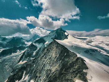 Aerial view of snowcapped mountains against sky