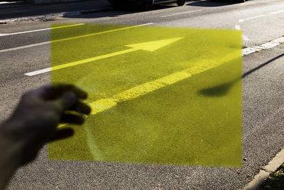 Shadow of person on yellow umbrella