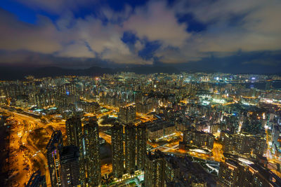 High angle view of illuminated cityscape against sky at dusk