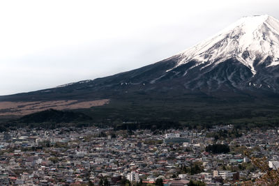 Aerial view of townscape against mountain range