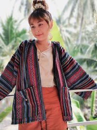 Portrait of young woman standing outdoors