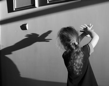 Man photographing against wall