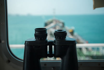 Close-up of binoculars on ship