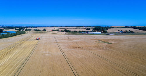 High angle view of agricultural field against blue sky
