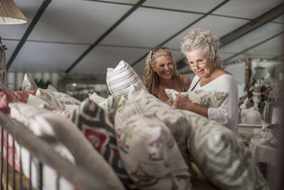 Two women shopping for pillows in vintage store