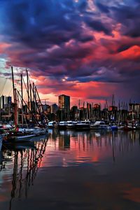 Boats in harbor with city in background