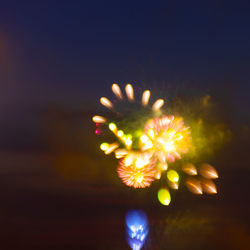 Close-up of illuminated fireworks against sky at night