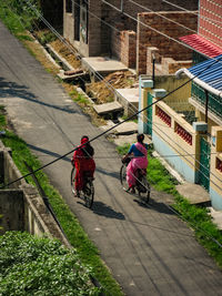 High angle view of people walking on road