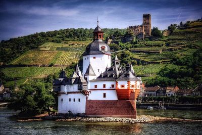 Pfalz castle by river rhine against agricultural field