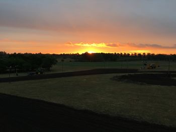 Scenic view of landscape against sky at sunset