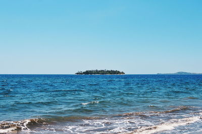 Scenic view of sea against clear blue sky