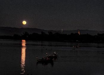 Scenic view of lake against sky at night