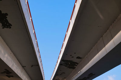 Low angle view of bridge against buildings