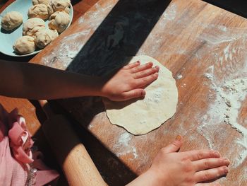 High angle view of girl preparing dough