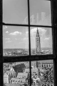 Close-up of cityscape against sky seen through window