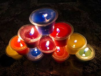High angle view of illuminated tea light candles in building