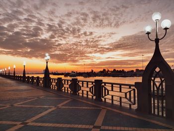 View of illuminated street against sky during sunset