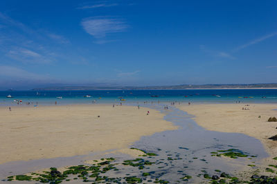 Scenic view of beach against blue sky