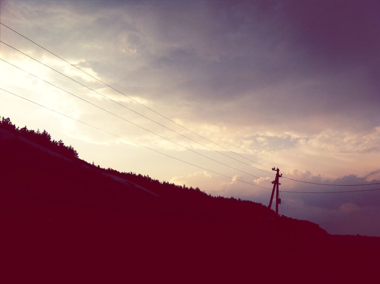 silhouette, electricity pylon, sky, tranquility, power line, tranquil scene, low angle view, scenics, sunset, beauty in nature, electricity, nature, landscape, technology, fuel and power generation, dusk, power supply, mountain, cable, connection