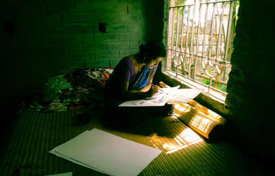 Woman sitting on book