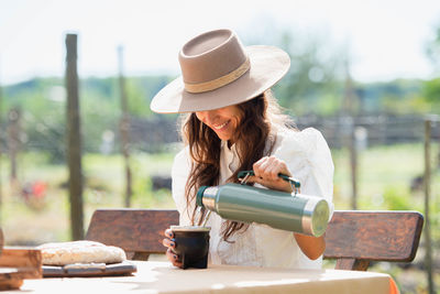 Woman wearing hat on table