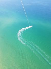 High angle view of vapor trails in sea