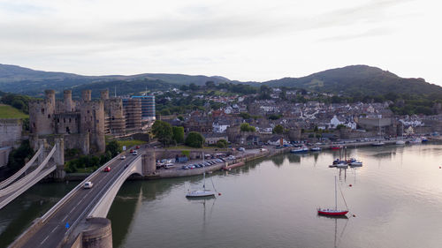 High angle view of river amidst cityscape against sky