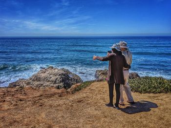 Man standing at beach against sky